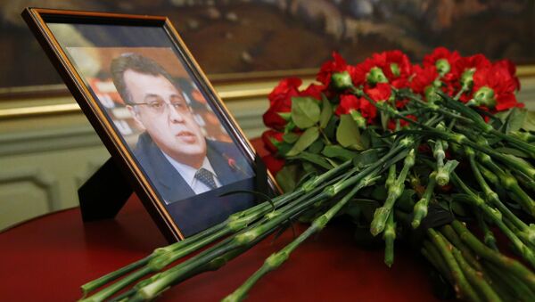 Flowers lay next to a portrait in memory of Russian Ambassador to Turkey Andrei Karlov, who was fatally shot by a Turkish policeman Monday in a gathering in Ankara, Turkey, before their talks on Syria in Moscow, Russia, Tuesday, Dec. 20, 2016. - Sputnik Afrique