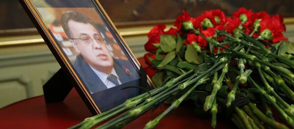 Flowers lay next to a portrait in memory of Russian Ambassador to Turkey Andrei Karlov, who was fatally shot by a Turkish policeman Monday in a gathering in Ankara, Turkey, before their talks on Syria in Moscow, Russia, Tuesday, Dec. 20, 2016. - Sputnik Afrique
