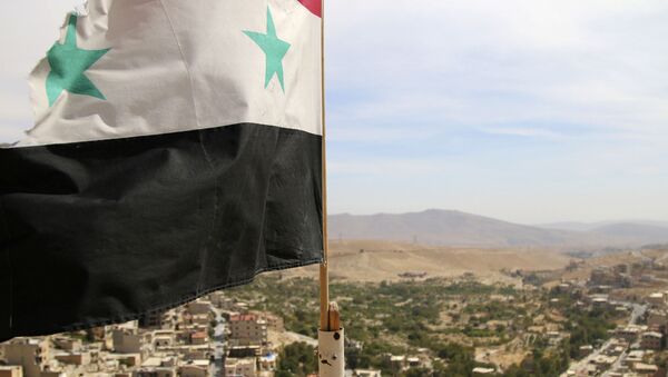 In this photo taken on Sunday, Oct. 18, 2015, a Syrian flag flies above the village of Maaloula, north of Damascus, Syria - Sputnik Afrique