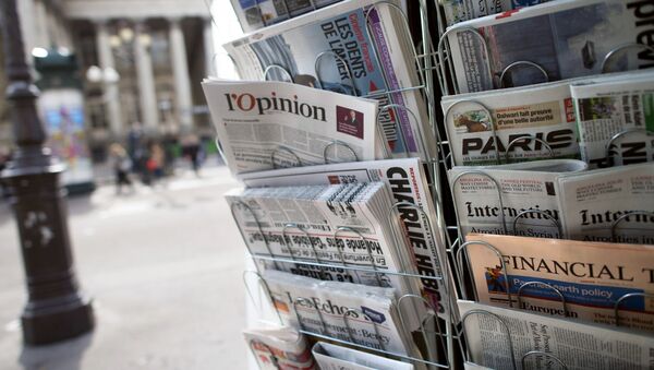 A copy of the newspaper L'opinion is pictured amongst other newspapers in a newsstand on May 15, 2013 in Paris. - Sputnik Afrique