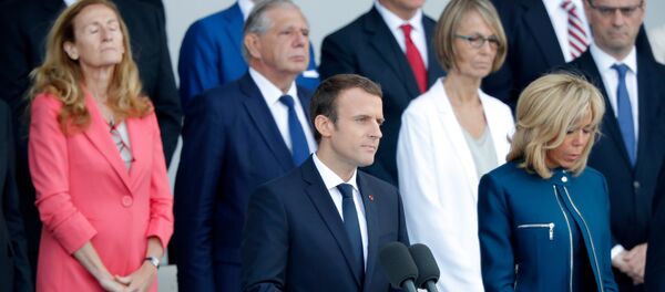 French President Emmanuel Macron delivers a speech next to his wife Brigitte Macron at the end of the traditional Bastille Day military parade on the Champs-Elysees in Paris, France, July 14, 2017. - Sputnik Afrique