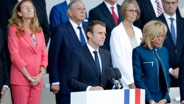 French President Emmanuel Macron delivers a speech next to his wife Brigitte Macron at the end of the traditional Bastille Day military parade on the Champs-Elysees in Paris, France, July 14, 2017. - Sputnik Afrique