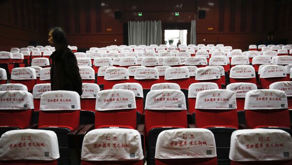 In this Dec. 12, 2016 photo, Wang Xudong, the manager of Zhuolu County Digital Cinema, checks on the main screening hall in Zhuolu county in north China's Hebei province. The brightly-decorated 3-D cinema in this town outside Beijing is showing the latest Chinese and Hollywood films, to row after row of empty red seats. - Sputnik Afrique