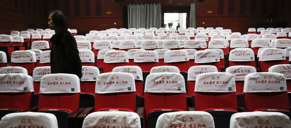 In this Dec. 12, 2016 photo, Wang Xudong, the manager of Zhuolu County Digital Cinema, checks on the main screening hall in Zhuolu county in north China's Hebei province. The brightly-decorated 3-D cinema in this town outside Beijing is showing the latest Chinese and Hollywood films, to row after row of empty red seats. - Sputnik Afrique