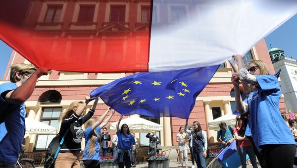 Young people wave Polish and European Union flags during the yearly Schumann Parade supporting EU ideas, in Warsaw, Poland, Saturday, May 7, 2016. - Sputnik Afrique