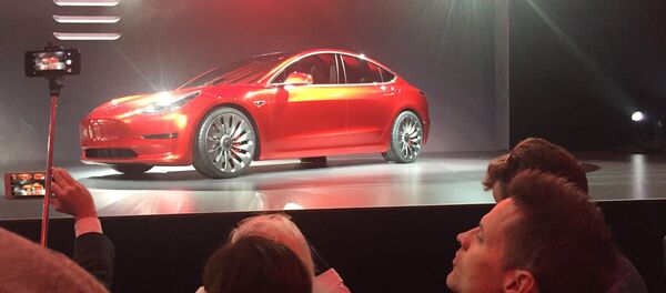 A Tesla Model 3 sedan, its first car aimed at the mass market, is displayed during its launch in Hawthorne, California, March 31, 2016 - Sputnik Afrique