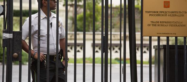 Сотрудник полиции стоит в оцеплении у здания российского торгового представительства в Вашингтоне - Sputnik Afrique