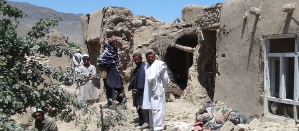 Afghan villagers gather near a destroyed house in Logar province, south of Kabul, Afghanistan (File) - Sputnik Afrique