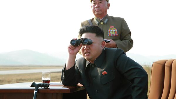 North Korean leader Kim Jong Un looks through a pair of binoculars as he guides a flight drill for the inspection of airmen of the Korean People's Army (KPA) - Sputnik Afrique