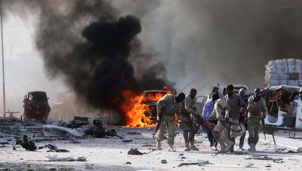 Somali Armed Forces evacuate their injured colleague, from the scene of an explosion in KM4 street in the Hodan district of Mogadishu, Somalia October 14, 2017. - Sputnik Afrique