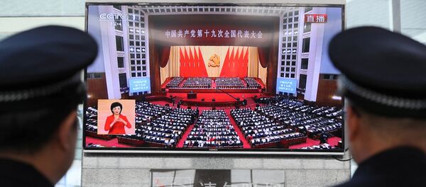 Policemen watch a broadcast of Chinese President Xi Jinping delivering his speech during the opening of the 19th National Congress of the Communist Party of China, as they stand guard at a railway station in Yuncheng, Shanxi province, China October 18, 2017. - Sputnik Afrique