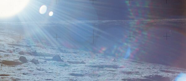 The Surveyor III craft can hardly be seen rightward in the shadow of a crater on Moon's surface in this contre-jour picture taken by astronaut Richard F. Gordon on November 19, 1969 during the Apollo 12 space mission. - Sputnik Afrique