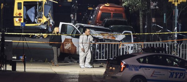 Police work near a damaged Home Depot truck after a motorist drove onto a bike path near the World Trade Center memorial, striking and killing several people, Wednesday, Nov. 1, 2017, in New York. - Sputnik Afrique