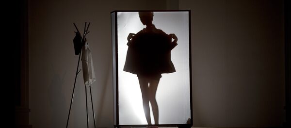 A model is silhouetted on stage as she prepares to present La Nouvelle Famille home wear collections by Chinese designer Ma Bin during China Fashion Week in Beijing Thursday, Oct. 31, 2013. - Sputnik Afrique