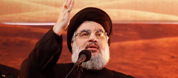 Lebanon's Hezbollah leader Sayyed Hassan Nasrallah addresses his supporters during a rare public appearance at an Ashoura ceremony in Beirut's southern suburbs November 3, 2014 - Sputnik Afrique