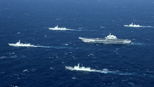 China's Liaoning aircraft carrier with accompanying fleet conducts a drill in an area of South China Sea in this undated photo taken December, 2016 - Sputnik Afrique