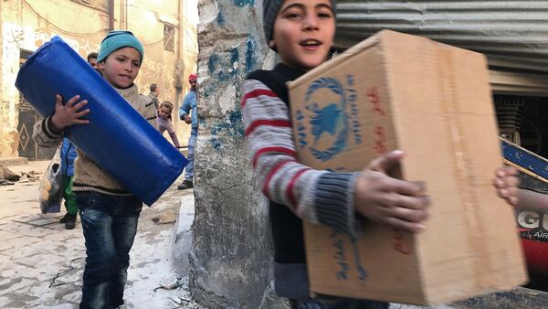 Des enfants reçoivent de l'aide humanitaire à Alep - Sputnik Afrique