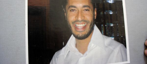 A reproduction of a photo of Moamer Kadhafi's son Saadi, from an album dated 2006 and sent to him as a new year's gift by a New York-based friend called Linda, is taken on August 29, 2011 after it was found at his abandoned rest house in Tripoli. - Sputnik Afrique