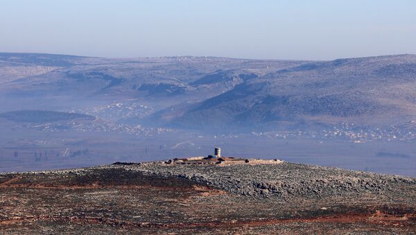 A picture taken on January 20, 2018, from the village of Qilah in the Idlib province, shows a Kurdish forces watchtower located in the Afrin countryside. - Sputnik Afrique