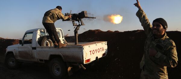 Turkish-backed fighters from the Free Syrian Army stand in the Tal Malid area, north of Aleppo, as they fire towards Kurdish People's Protection Units (YPG) positions in the village of Um al-Hosh, in the area of Afrin, on January 20, 2018. Turkish-backed fighters from the Free Syrian Army stand in the Tal Malid area, north of Aleppo, as they fire towards Kurdish People's Protection Units (YPG) positions in the village of Um al-Hosh, in the area of Afrin, on January 20, 2018. - Sputnik Afrique