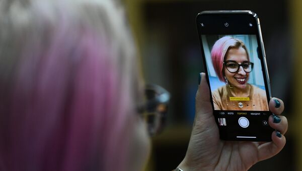 A girl takes a selfie with a new Apple's iPhone X to go on sale in Russia. File photo - Sputnik Afrique