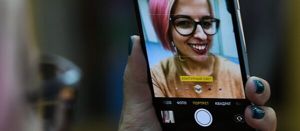 A girl takes a selfie with a new Apple's iPhone X to go on sale in Russia. File photo - Sputnik Afrique