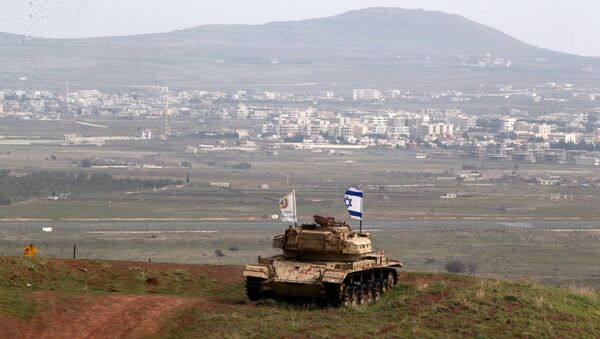 An old military vehicle can be seen positioned on the Israeli side of the border with Syria, near the Druze village of Majdal Shams in the Israeli-occupied Golan Heights, Israel February 11, 2018 - Sputnik Afrique