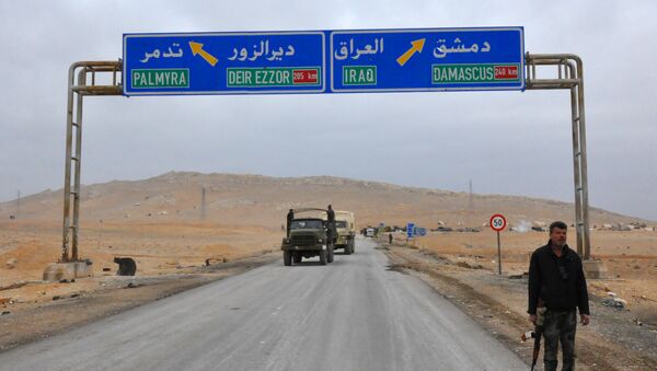 A picture taken on March 2, 2017, shows a sign displaying the routes to Palmyra-Deir Ezzor and Damascus-Iraq - Sputnik Afrique