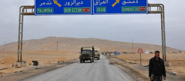 A picture taken on March 2, 2017, shows a sign displaying the routes to Palmyra-Deir Ezzor and Damascus-Iraq - Sputnik Afrique