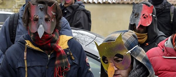 Anti-nuclear activists hold a banner featuring an image of French Minister for the Ecological and Inclusive Transition Nicolas Hulot as they speak with media representatives in Mandres-en-Barrois, eastern France on March 3, 2018, following a meeting of anti-nuclear activists. - Sputnik Afrique