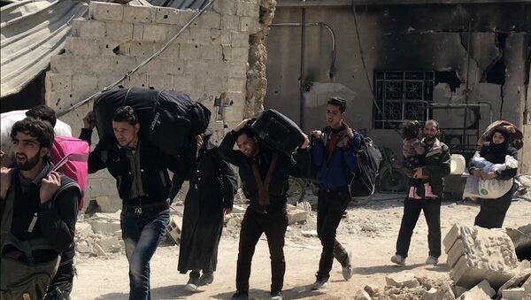 Des civils quittent la Ghouta orientale par le couloir humanitaire à Hammouria - Sputnik Afrique