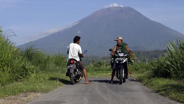 Villagers on their motorcycles talk each other with Mount Agung volcano in the background in Karangasem, Bali, Indonesia, Wednesday, Oct. 25, 2017 - Sputnik Afrique