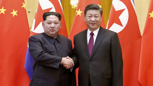 Kim Jong Un et Xi Jingping - Sputnik Afrique
