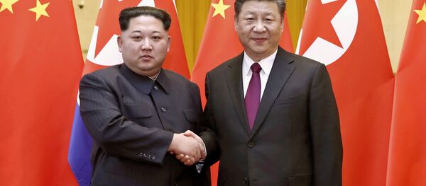 Kim Jong Un et Xi Jingping - Sputnik Afrique