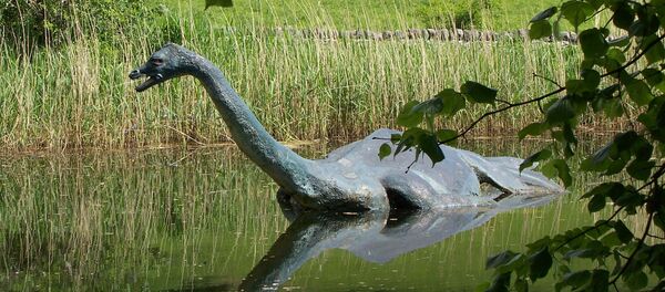 In this June 2006 file photo a model monster replica of the legendary sea serpent of Loch Ness, Nessie, provides a photo op for visitors in Drumnadrochit, Scotland - Sputnik Afrique