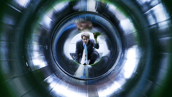 A man looks into a tube representing a natural gas pipeline at the booth of Nord Stream at the Hanover industrial fair in Hanover, Germany (File) - Sputnik Afrique