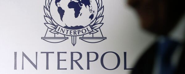 A man passes an Interpol logo during the handing over ceremony of the new premises for Interpol's Global Complex for Innovation, a research and development facility, in Singapore September 30, 2014 A man passes an Interpol logo during the handing over ceremony of the new premises for Interpol's Global Complex for Innovation, a research and development facility, in Singapore September 30, 2014 - Sputnik Afrique