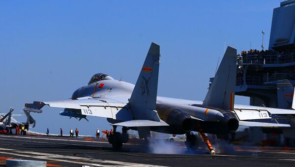 This photo taken on April 24, 2018 shows a J15 fighter jet landing on China's sole operational aircraft carrier, the Liaoning, during a drill at sea - Sputnik Afrique