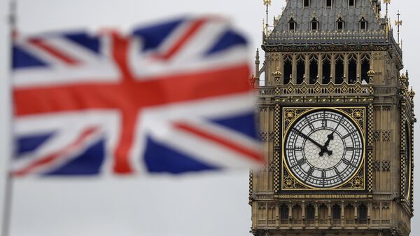 a British flag is blown by the wind near to Big Ben's clock tower in front of the UK Houses of Parliament in central London - Sputnik Afrique