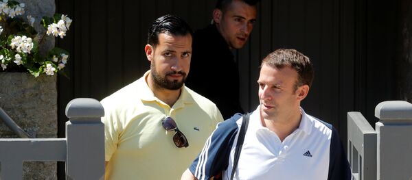 French President Emmanuel Macron, flanked by Alexandre Benalla, French presidential aide, carries a racquet as he leaves his home to play tennis in Le Touquet, France, June 17, 2017. Picture taken June 17, 2017 - Sputnik Afrique
