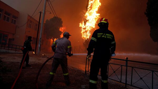 Firefighters and soldiers try to extinguish a wildfire burning in the town of Rafina, near Athens, Greece, July 23, 2018 - Sputnik Afrique