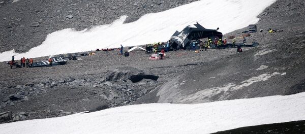 Accident investigators and rescue personnel gather around the wreckage of a Junkers JU52 aircraft at Flims on August 5, 2018, after the aeroplane crashed into Piz Segnas, a 3,000-metre (10,000-foot) peak in eastern Switzerland on August 4. - Sputnik Afrique