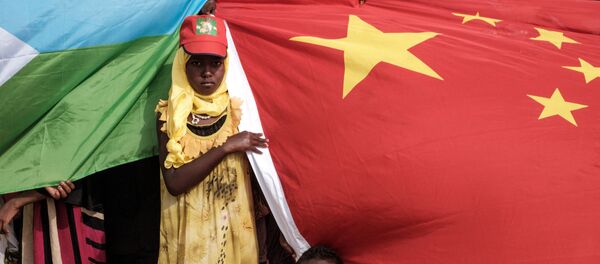 People hold Chinese and Djiboutian national flags as they wait for the arrival of Djibouti's President Ismail Omar Guellehas before the launching ceremony of new 1000-unit housing contruction project in Djibouti, on July 4, 2018. People hold Chinese and Djiboutian national flags as they wait for the arrival of Djibouti's President Ismail Omar Guellehas before the launching ceremony of new 1000-unit housing contruction project in Djibouti, on July 4, 2018. - Sputnik Afrique