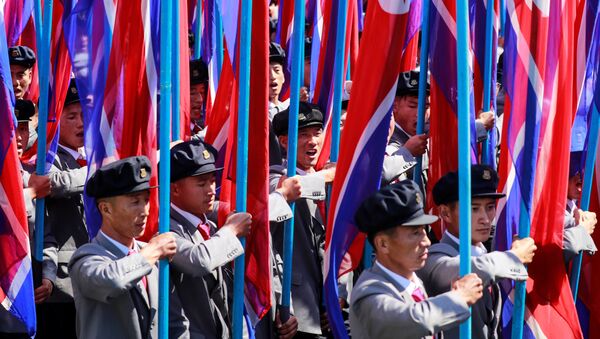 People carry North Korean national flags during a military parade marking the 70th anniversary of North Korea's foundation in Pyongyang, North Korea, September 9, 2018. - Sputnik Afrique