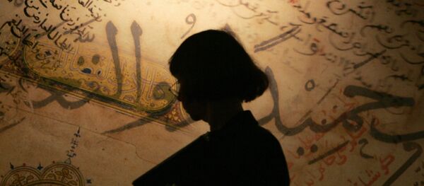 A vistors walks past reproductions of old Arabic manuscripts at the stand of the Biblioteca Alexandrina (Egypt) during the Frankfurt Book Fair 06 October 2004. - Sputnik Afrique