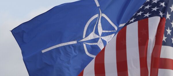 NATO and US flags wave in the wind outside NATO headquarters in Brussels on Friday, Oct. 21, 2011. - Sputnik Afrique