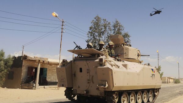 File photo, Egyptian Army soldiers patrol in an armored vehicle backed by a helicopter gunship during a sweep through villages in Sheikh Zuweyid, north Sinai, Egypt - Sputnik Afrique
