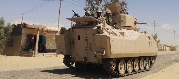 File photo, Egyptian Army soldiers patrol in an armored vehicle backed by a helicopter gunship during a sweep through villages in Sheikh Zuweyid, north Sinai, Egypt - Sputnik Afrique