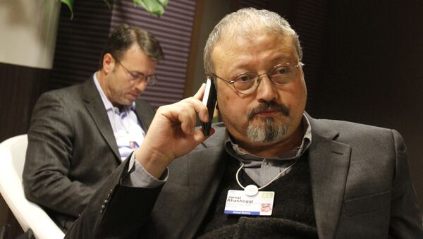 FILE - In this Jan. 29, 2011 file photo, Saudi journalist Jamal Khashoggi speaks on his cellphone at the World Economic Forum in Davos, Switzerland. Khashoggi was a Saudi insider - Sputnik Afrique