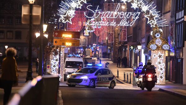 A police car drives in the streets of Strasbourg, eastern France, after a shooting breakout, on December 11, 2018 - Sputnik Afrique